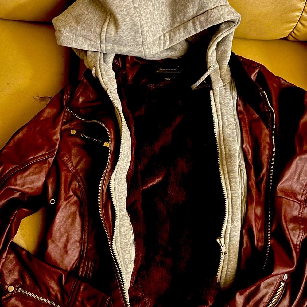 Maroon leather jacket, fur on the inside. Casual wear.
